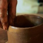 Finishing the rim on a coiled mug