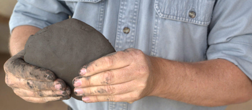 Pinching out a flat pancake of clay