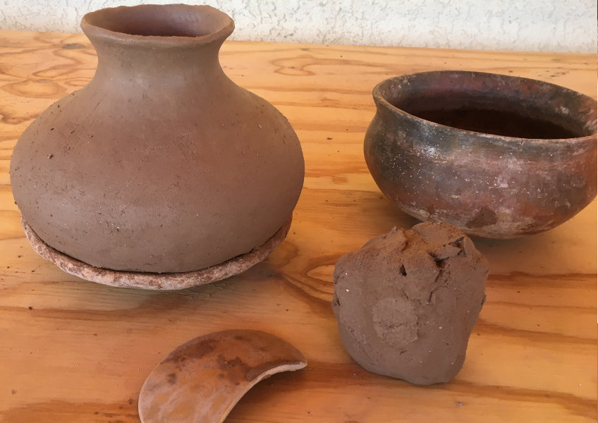 Hand building clay pottery in process.