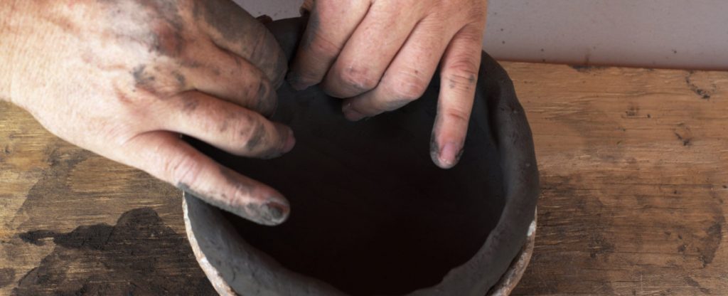 hand building a pot using coil method