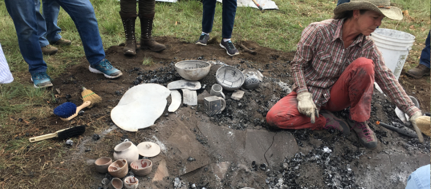 Cherylene Caver unloads a fired traditional Anasazi kiln