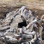 Pottery being fired in an outdoor wood fire