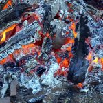 Pottery being fired among hot coals